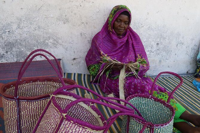 Jambiani Village Women at work and play - Kanga garment lesson: learning the wrap that shapes the look